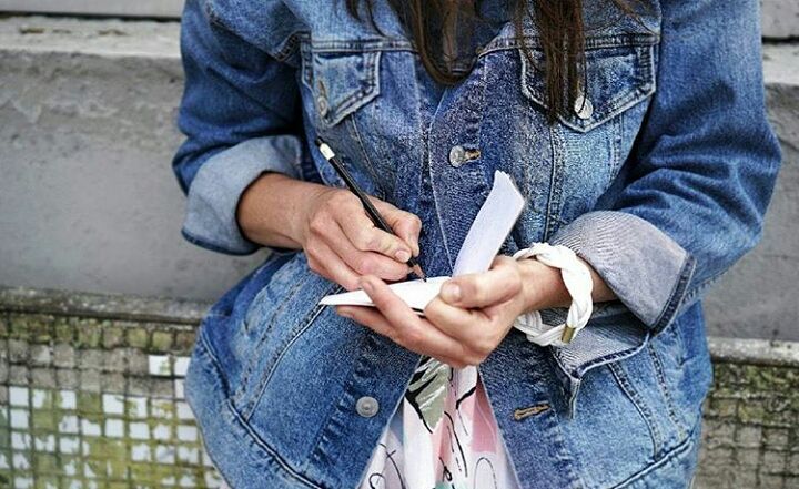 Ieva Drazniece writing in a notebook