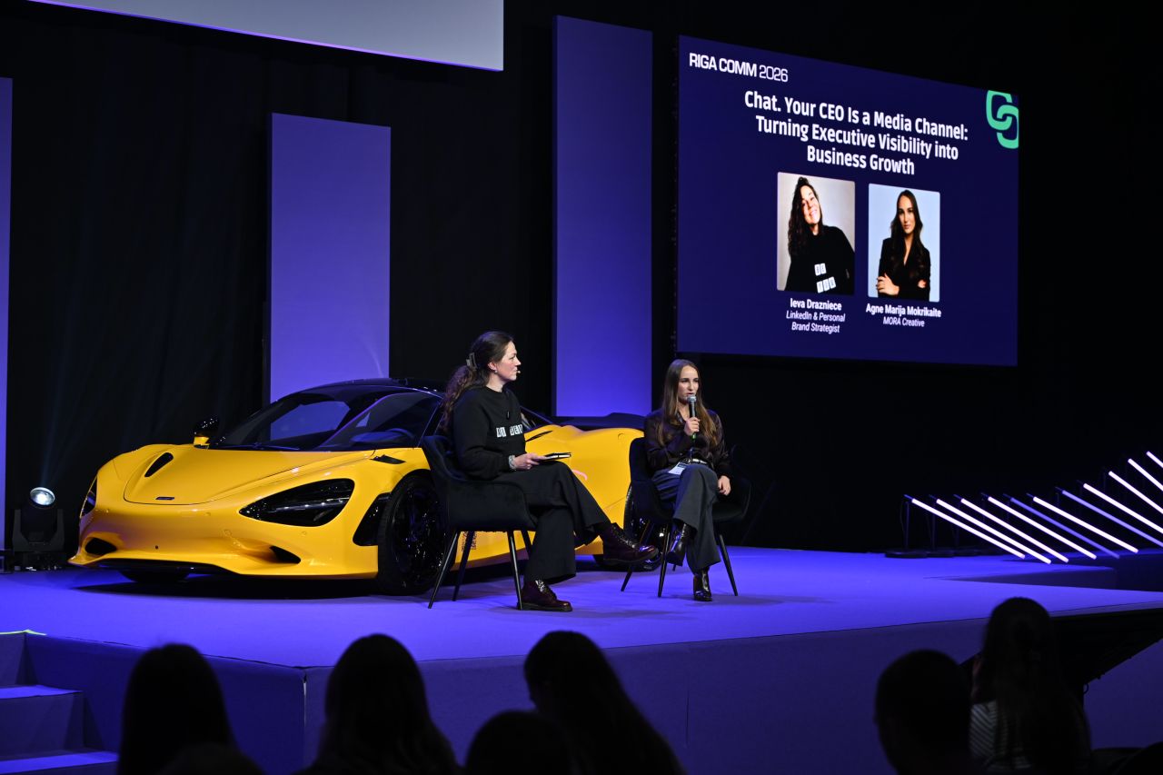 Ieva Drazniece in conversation on the Riga COMM 2026 stage for the session 'Your CEO Is a Media Channel: Turning Executive Visibility into Business Growth'